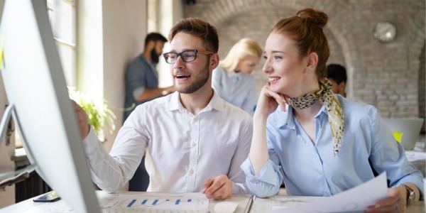 A digital marketing specialist looking at data with one of her colleagues.