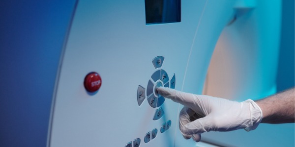 A radiologic technologist operating an MRI machine.
